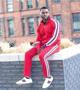 man wearing red tracksuit with sneakers