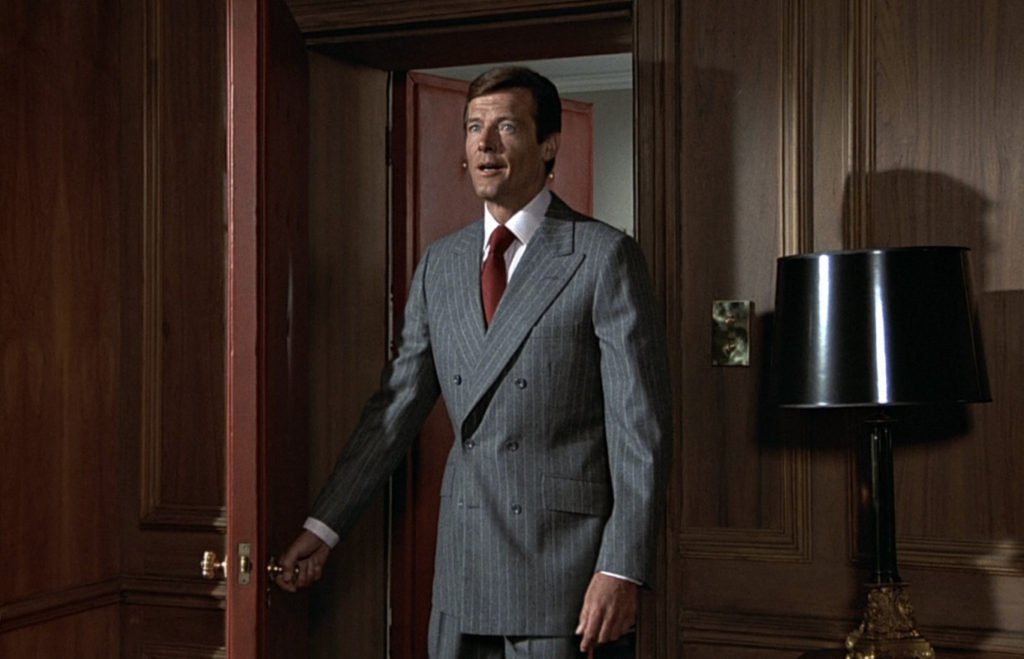 Roger Moore wearing gray stripe double breasted suit